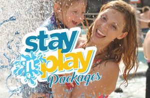 The stay 'n play logo. In the background of the picture are two guests smiling.